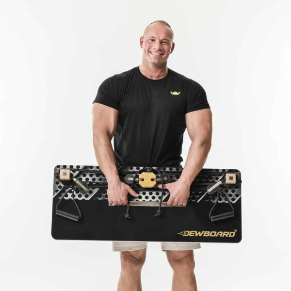 lachender, muskulöser Mann hält das Dewboard Pro smart Kraftsportgerät vor seinem Körper